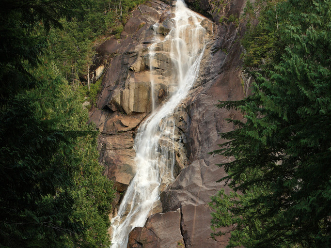 Shannon Falls pouring down a granite cliff through the forest